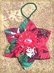 This Poinsettia ornament was made by Nancy Kuelbs. This ornament came from an inspiration Nancy had from something she saw online many years ago, and she loves making them.