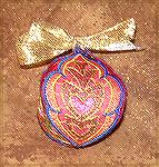 The ornament was machine embroidered by Tina Norton. It's from the "Elegant Oranments" design collection by John Deer.