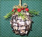 This pine cone was folded ribbon. It was folded to make a prairie point. The ribbon was 1 1/2" wide by 3 1/4" long. It had a fine wire in it. 
Kyra Tenpenny