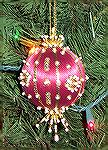 This ornament was made by Kyra Tenpenny. It was made from a Herrschners satin ornament kit.