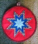 Round Amish folded star hot pad.
Kyra
