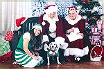 Lucy visiting with Santa, Mrs. Claus, and an elf. 2018.