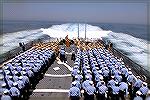 Arleigh Burke class Guided missile destroyer. Sailors assembled on the helicopter flight deck.